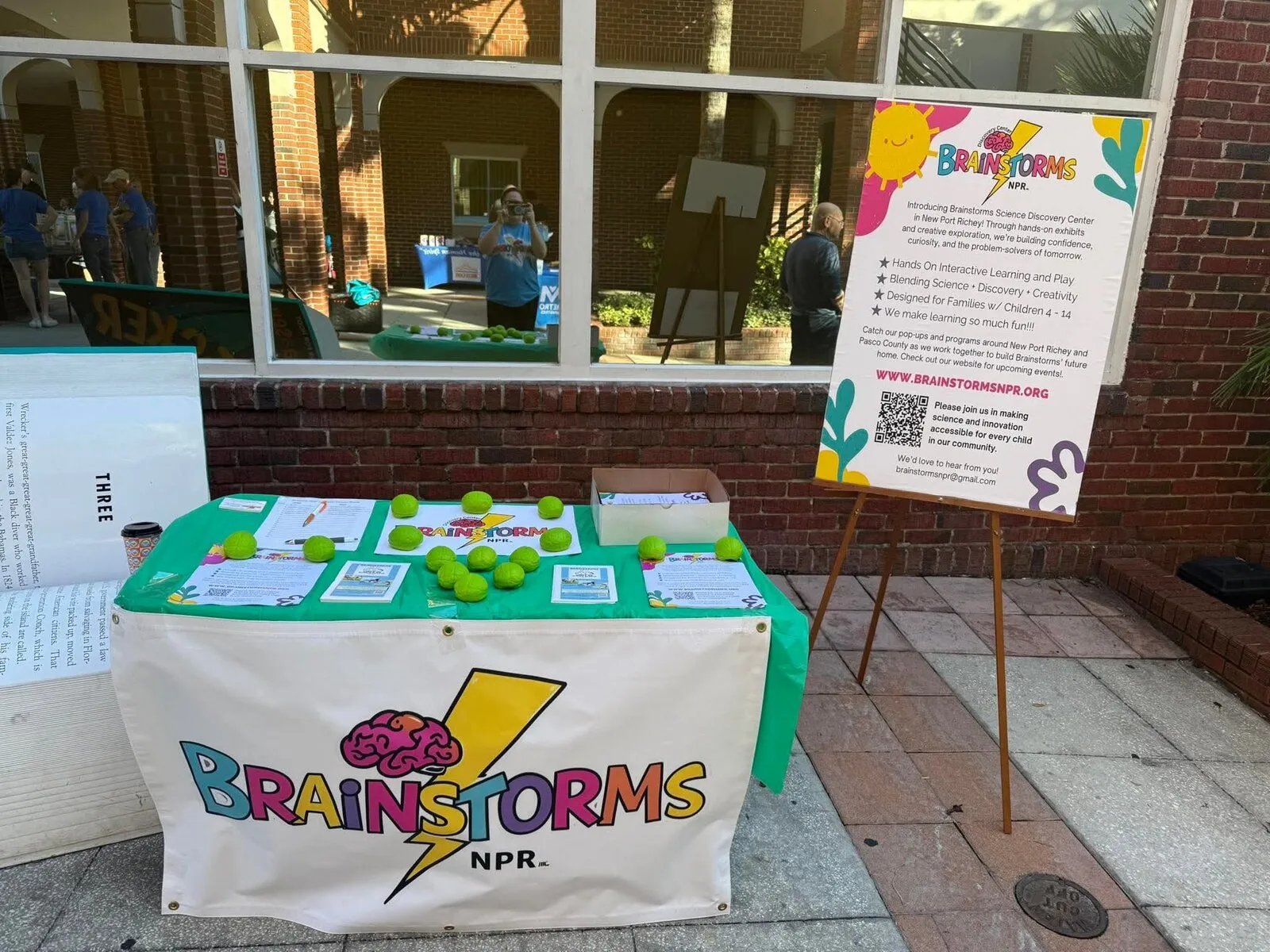 A Brainstorms popup table on a downtown sidewalk