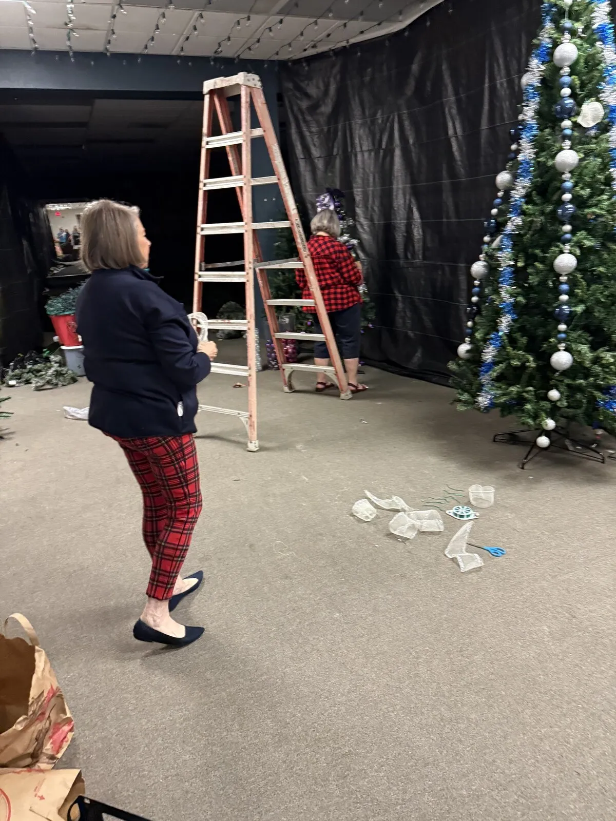 Volunteers set up decorations and lights for a Winter Wonderland community event